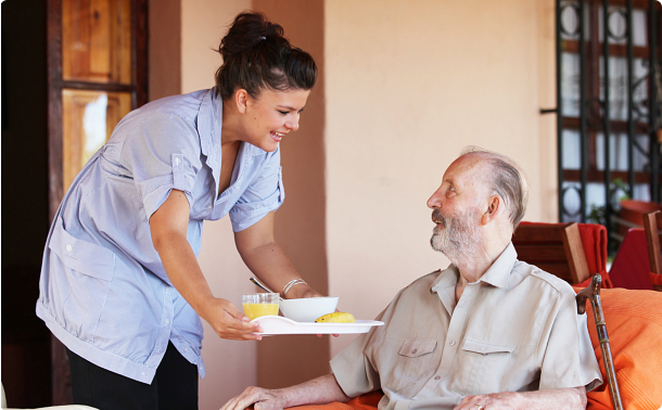 caregiver giving food to patient